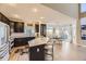 Well-designed kitchen with island and seating flowing into a bright dining area with large windows at 7378 Geode Ct, Castle Rock, CO 80108