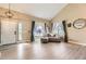 Inviting living room featuring high ceilings, large windows with sheer curtains, and comfortable seating at 7378 Geode Ct, Castle Rock, CO 80108
