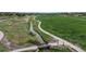 Aerial shot displays a well-maintained park with walking paths, a stream, and lush green fields at 10759 Clermont St, Thornton, CO 80233