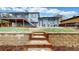 Landscaped backyard with stairs leading to the deck and a retaining wall at 10759 Clermont St, Thornton, CO 80233