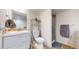 Modern bathroom with white vanity, sink, open shelving, and a glass shower stall at 10759 Clermont St, Thornton, CO 80233