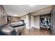 A neutral bedroom with a queen bed, wood floors, closet, and television at 10759 Clermont St, Thornton, CO 80233