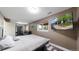 Bedroom with a queen bed, wood floors, and a mounted flatscreen television at 10759 Clermont St, Thornton, CO 80233