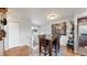 Bright dining area with a four-chair wooden table set, hardwood floors, and neutral wall color at 10759 Clermont St, Thornton, CO 80233
