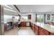 Spacious kitchen with stainless steel appliances, granite countertops, a large window, and hardwood flooring throughout the home at 10759 Clermont St, Thornton, CO 80233