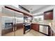 Modern kitchen featuring stainless steel appliances, granite countertops, and dark wood cabinetry with lots of natural light at 10759 Clermont St, Thornton, CO 80233