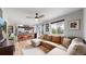 Open-concept living room and kitchen area featuring a large sectional sofa, granite counters and hardwood flooring at 10759 Clermont St, Thornton, CO 80233
