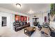 A cozy living room features a brick fireplace, leather couches, and sports memorabilia at 10759 Clermont St, Thornton, CO 80233