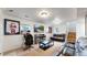 Spacious living room features a brick fireplace, leather couches, and mounted TV at 10759 Clermont St, Thornton, CO 80233