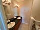 Bright bathroom featuring a dual sink vanity with a large mirror and stylish lighting fixtures at 15700 E Jamison Dr # 3-202, Englewood, CO 80112
