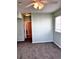 Bedroom featuring neutral carpet, a ceiling fan, and a view into an adjacent room through an open doorway at 15700 E Jamison Dr # 3-202, Englewood, CO 80112