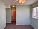 Bedroom featuring neutral carpet, a ceiling fan, and a view into an adjacent room through an open doorway at 15700 E Jamison Dr # 3-202, Englewood, CO 80112