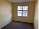 Cozy bedroom with neutral walls and carpet and a window bringing in natural light at 15700 E Jamison Dr # 3-202, Englewood, CO 80112
