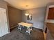Dining room features modern lighting and neutral tones at 15700 E Jamison Dr # 3-202, Englewood, CO 80112