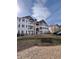 Apartment building exterior featuring balconies, neutral tones, and well-maintained landscaping at 15700 E Jamison Dr # 3-202, Englewood, CO 80112