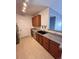 Kitchen with wood cabinets, a black sink, and stainless steel appliances at 15700 E Jamison Dr # 3-202, Englewood, CO 80112