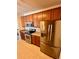 Kitchen featuring stainless steel appliances, granite countertops, and wood cabinets at 15700 E Jamison Dr # 3-202, Englewood, CO 80112
