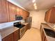 Kitchen with wood cabinets, stainless steel appliances, and granite countertops at 15700 E Jamison Dr # 3-202, Englewood, CO 80112