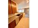 Kitchen featuring stainless steel appliances, granite countertops, wood cabinets, and tile flooring at 15700 E Jamison Dr # 3-202, Englewood, CO 80112