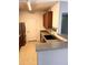 Kitchen with wood cabinets, a black sink, and stainless steel appliances at 15700 E Jamison Dr # 3-202, Englewood, CO 80112