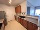 Kitchen with wood cabinets, a black sink, and stainless steel appliances at 15700 E Jamison Dr # 3-202, Englewood, CO 80112