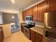 Well-equipped kitchen featuring stainless steel appliances and wood cabinetry and dining area at 15700 E Jamison Dr # 3-202, Englewood, CO 80112