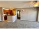 Open-concept living area with a view of the modern kitchen at 15700 E Jamison Dr # 3-202, Englewood, CO 80112