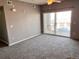 The spacious living area has a sliding door leading to a balcony at 15700 E Jamison Dr # 3-202, Englewood, CO 80112