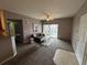 Cozy living area with neutral tones and access to the outdoor balcony at 15700 E Jamison Dr # 3-202, Englewood, CO 80112
