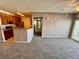 Open-concept living area with a view of the modern kitchen at 15700 E Jamison Dr # 3-202, Englewood, CO 80112