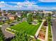 Aerial view of a vibrant neighborhood park and playground with lush greenery and walking paths at 8427 E 35Th Ave, Denver, CO 80238