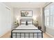 Bedroom features neutral walls, window with shutter, and stylish decorations at 8427 E 35Th Ave, Denver, CO 80238