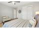 Bright bedroom boasts a ceiling fan and closet to maximize storage at 8427 E 35Th Ave, Denver, CO 80238