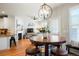 Open-concept living and dining area with a fireplace and lots of natural light at 8427 E 35Th Ave, Denver, CO 80238