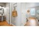 Hallway featuring a powder room, coat closet and access to the upper level at 8427 E 35Th Ave, Denver, CO 80238