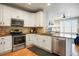 Bright kitchen featuring stainless steel appliances and a tile backsplash at 8427 E 35Th Ave, Denver, CO 80238