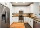 Well-lit kitchen with stainless steel appliances, granite countertops, and white cabinetry at 8427 E 35Th Ave, Denver, CO 80238