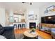 Open concept living room flows into the kitchen with bar seating and modern finishes at 8427 E 35Th Ave, Denver, CO 80238