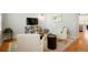 Bright living room offering stylish seating, a mounted TV and light hardwood floors at 8427 E 35Th Ave, Denver, CO 80238