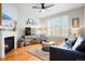 Cozy living room featuring a fireplace, hardwood floors, and a comfortable leather sofa at 8427 E 35Th Ave, Denver, CO 80238