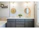 Beautiful primary bathroom with double sinks, custom cabinetry and mosaic tile at 8427 E 35Th Ave, Denver, CO 80238