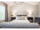 Luxurious main bedroom with a tufted headboard and neutral decor at 8427 E 35Th Ave, Denver, CO 80238