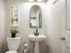 Charming powder room with pedestal sink and modern fixtures at 8427 E 35Th Ave, Denver, CO 80238