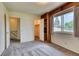 A bright bedroom featuring a closet, stairway, and view to the outdoors at 3351 S Field St # 191, Lakewood, CO 80227