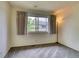 A cozy bedroom with a large window and comfortable carpet at 3351 S Field St # 191, Lakewood, CO 80227