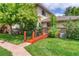 Charming home featuring well-maintained landscaping and an inviting entryway bridge at 3351 S Field St # 191, Lakewood, CO 80227