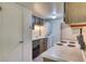 Efficient kitchen with appliances and washer/dryer combo at 3351 S Field St # 191, Lakewood, CO 80227