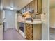 Functional kitchen featuring wood cabinetry and essential appliances at 3351 S Field St # 191, Lakewood, CO 80227