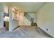 Open living room area with stairs, and a view of the kitchen featuring a serving hatch at 3351 S Field St # 191, Lakewood, CO 80227