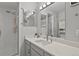 Bathroom featuring a glass shower, quartz countertop and a large mirror at 13950 E Oxford Pl # A-104, Aurora, CO 80014